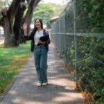 Young Student Waving Goodbye on a Sunny Day-cm